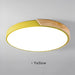 Yellow round wooden LED ceiling light with modern design and frosted finish.