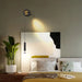 Adjustable Nordic Double Head LED Wall Lamp illuminating modern bedroom interior.