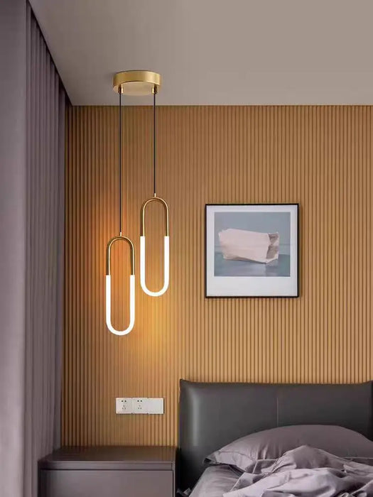 Minimalist U-Shaped Bar Chandelier in modern bedroom, polished chrome finish, white LED light, ideal for parlor or study.