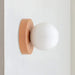 Modern LED wall sconce with frosted glass globe in minimalist design, ideal for cozy lighting in bedrooms and hallways.