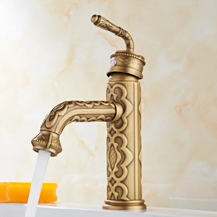 Antique brass swivel basin faucet with flowing water, showcasing vintage design and bronze finish.