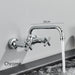 Chrome Elite Kitchen Wall-Mount Mixer Tap with double handles and 360-degree spout.