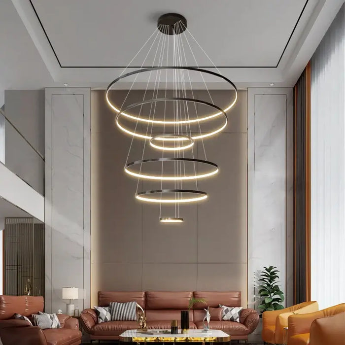 Modern LED multi-ring chandelier illuminating a stylish living room.