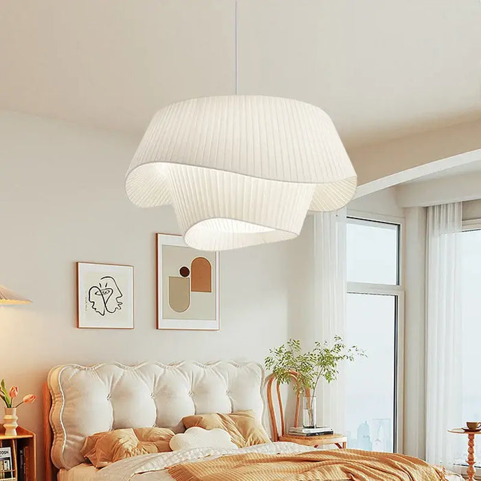 Elegant white wave fabric ceiling light with double-shade design in a cozy bedroom setting.