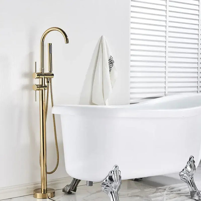 Modern Swivel Spout Freestanding Bath Mixer in gold beside a white clawfoot bathtub in a stylish bathroom setting.