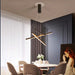 Modern smart chandelier with dimmable lighting over a dining table in a stylish room.