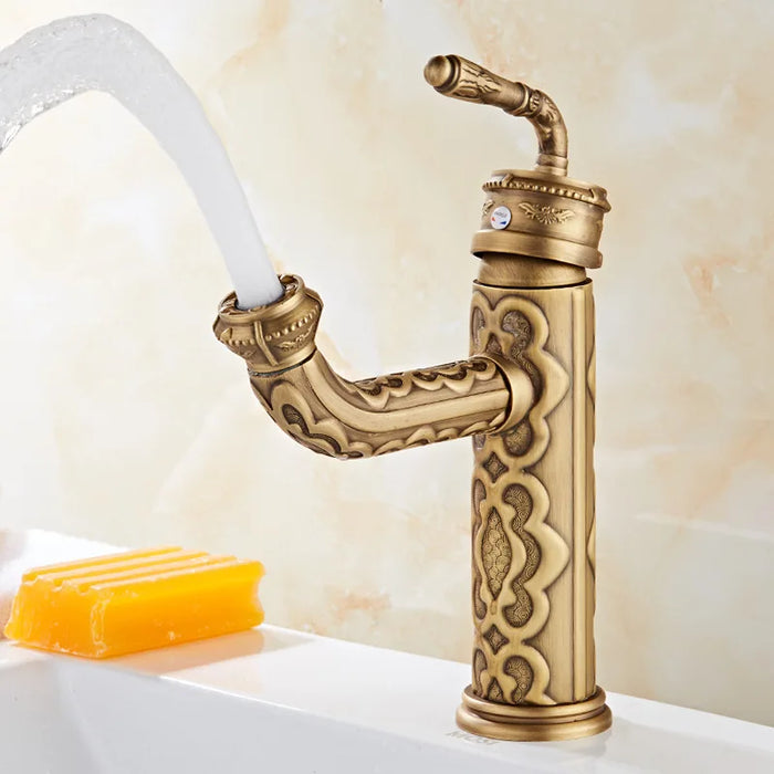 Antique Brass Swivel Basin Faucet with vintage design and 360-degree swivel spout in bathroom setting.