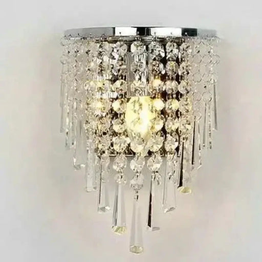 Elegant crystal wall sconce with clear crystals and premium hardware, illuminating modern interiors like a dining room or foyer.