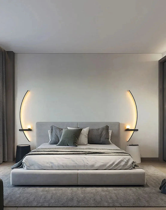 Modern bedroom with elegant line wall lights above a contemporary bed setting.