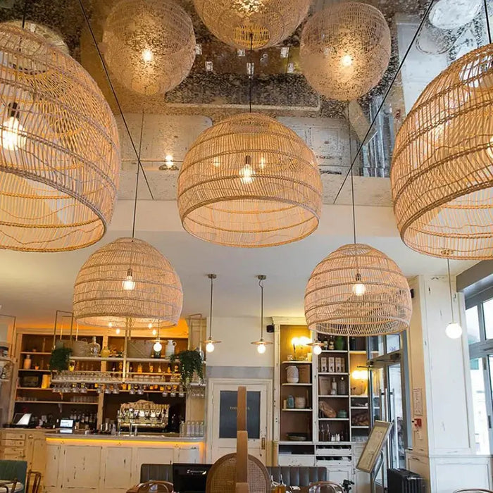 Handwoven bamboo pendant lights illuminating a modern dining area with warm, inviting ambiance and aesthetic appeal.