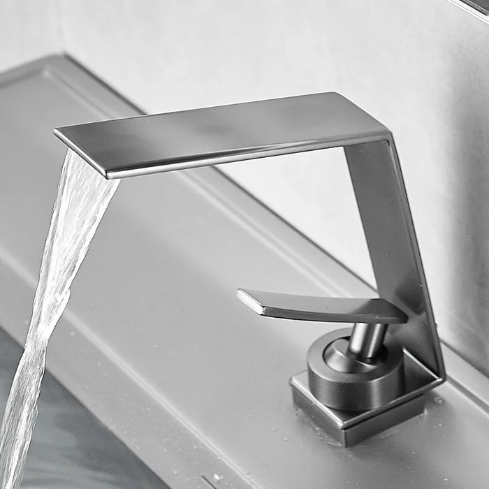 Ultra-thin waterfall basin faucet in grey with modern single-handle design, featuring a sleek waterfall flow for bathroom sinks.