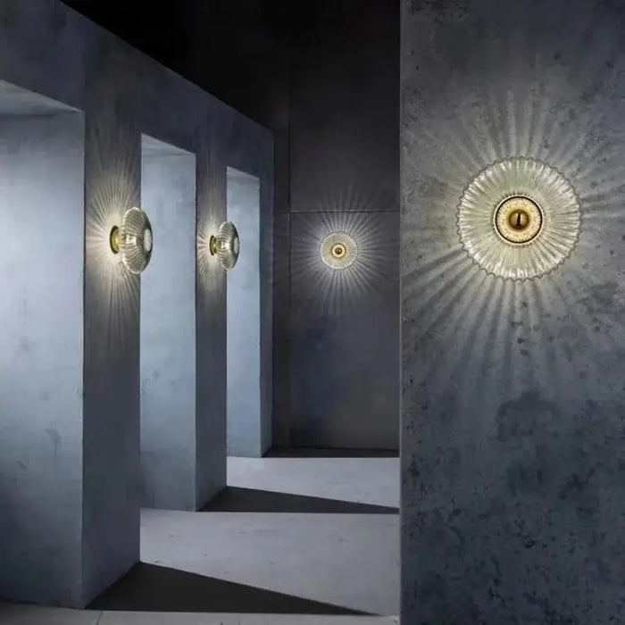 Modern LED glass ripple pattern wall lamp illuminating a corridor with elegant light design.