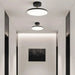 Modern rotatable LED ceiling light with minimalist design in a contemporary hallway setting.