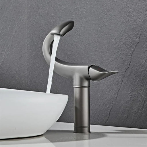 Elegant flamingo-inspired deck-mount basin faucet with flowing water, featuring modern design and single-handle control.