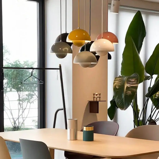 Modern dining area with colorful Danish Flower Bud Pendant Lights, sleek design, warm ambiance, and contemporary home decor.