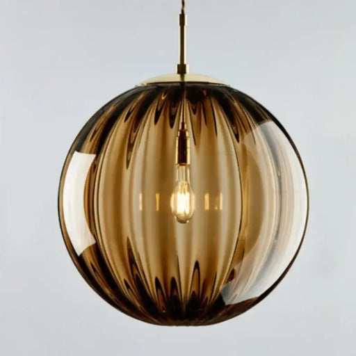 Brown glass ball pendant light with LED bulb, featuring modern design and high-quality craftsmanship for dining or living areas.