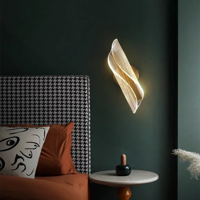 Modern Leo Lumis wall lamp illuminating a stylish bedroom with dark green walls and decorative elements.