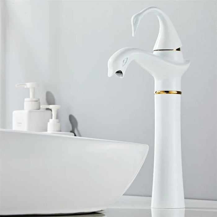 White and gold Tall Swan Basin Faucet next to a modern bathroom sink.