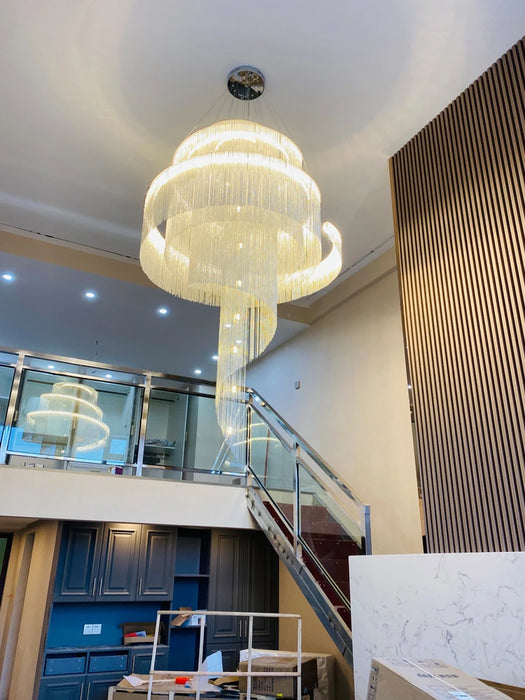 Modern Loft Spiral Chandelier with golden tassels in a contemporary interior setting.