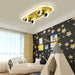 Skateboard ceiling lamp in modern children’s room with yellow and black design, creating playful decor with star-themed wallpaper.