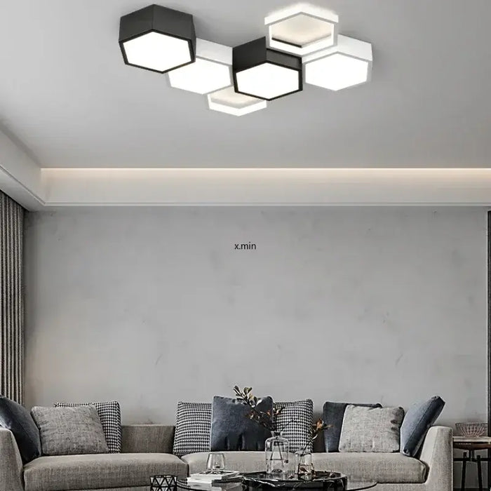 Modern hexagon-designed ultrathin LED ceiling light enhances a stylish living room with energy-efficient lighting.