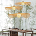 Japanese bamboo pendant lamp chandelier illuminating a modern dining area with bamboo decor and wooden table.