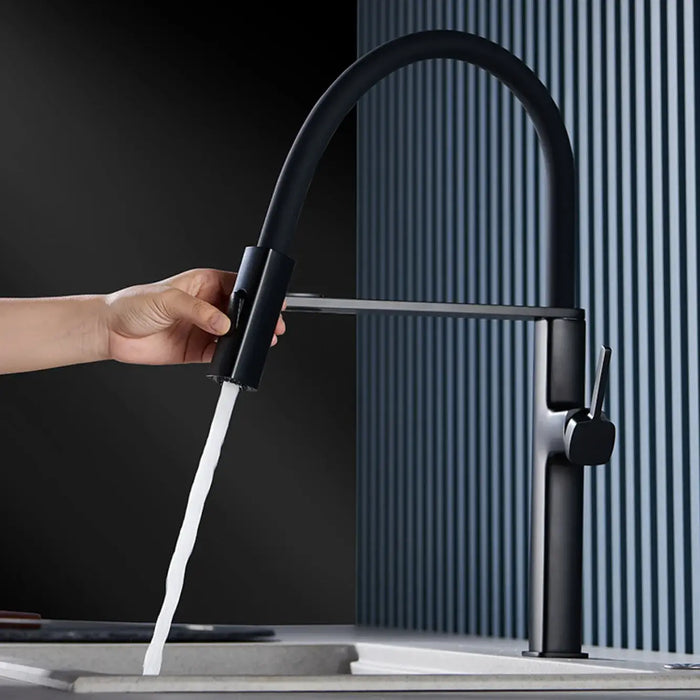 Luxury magnetic kitchen faucet with elegant black finish and dual-function spout in use, showcasing sleek modern design.