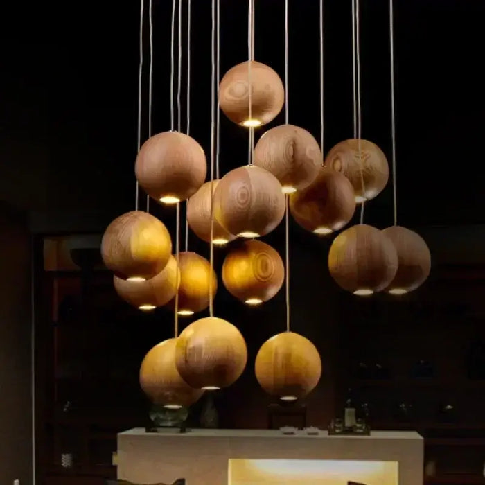 Solid wood pendant light with handcrafted spheres illuminating a modern space.