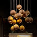 Solid wood pendant light with handcrafted spheres illuminating a modern space.