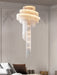 Modern loft spiral chandelier with golden tassels, illuminating a luxurious living room with contemporary elegance.