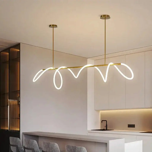 Modern Pencil LED Pendant Chandelier with elegant fluid design in a minimalist kitchen setting.