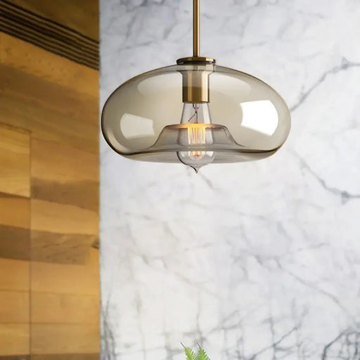 Modern industrial glass pendant lamp with translucent shade illuminating a contemporary space.