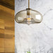 Modern industrial glass pendant lamp with translucent shade illuminating a contemporary space.