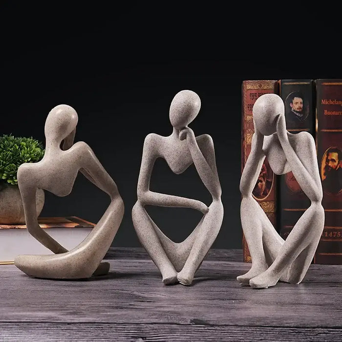 Modern resin thinker figurine set on a table, featuring minimalist abstract designs, adding sophistication to home or office decor.