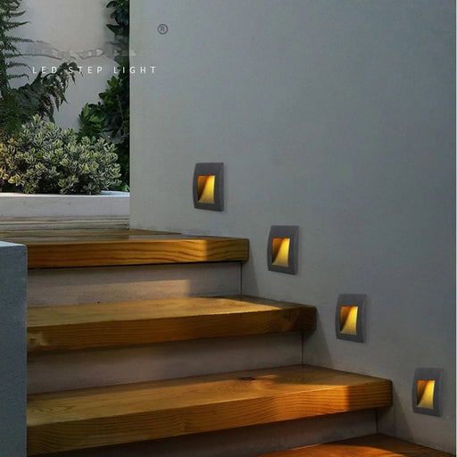 LED recessed stair lights with warm glow on wooden steps, modern design, waterproof IP65, ideal for indoor staircases.