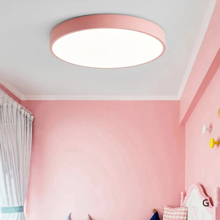 Modern round wooden LED ceiling light in a pink room, offers adjustable brightness and contemporary style, ideal for 5-10 sqm spaces.