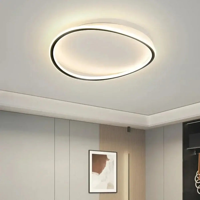 Modern LED ceiling flush mount lamp illuminating a stylish room with sleek, minimalist design.