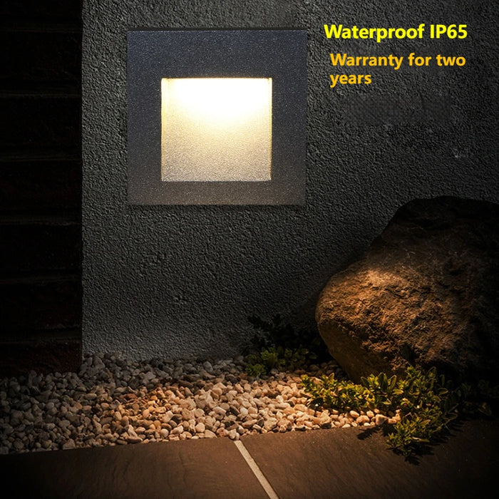 LED recessed stair light with modern design illuminating stone pathway, IP65 waterproof rating, two-year warranty, ideal for indoor use.