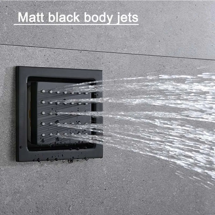 Matt black body jets spraying water on a gray tiled wall, showcasing a modern and stylish bathroom fixture design.