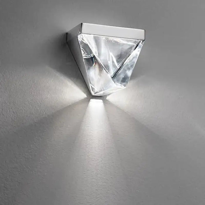 Luxury crystal wall lamp sconce with LED light casting elegant glow, perfect for modern home decor in living rooms and bedrooms.