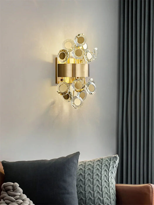 Modern luxury LED crystal wall lamp illuminating elegant living room decor.