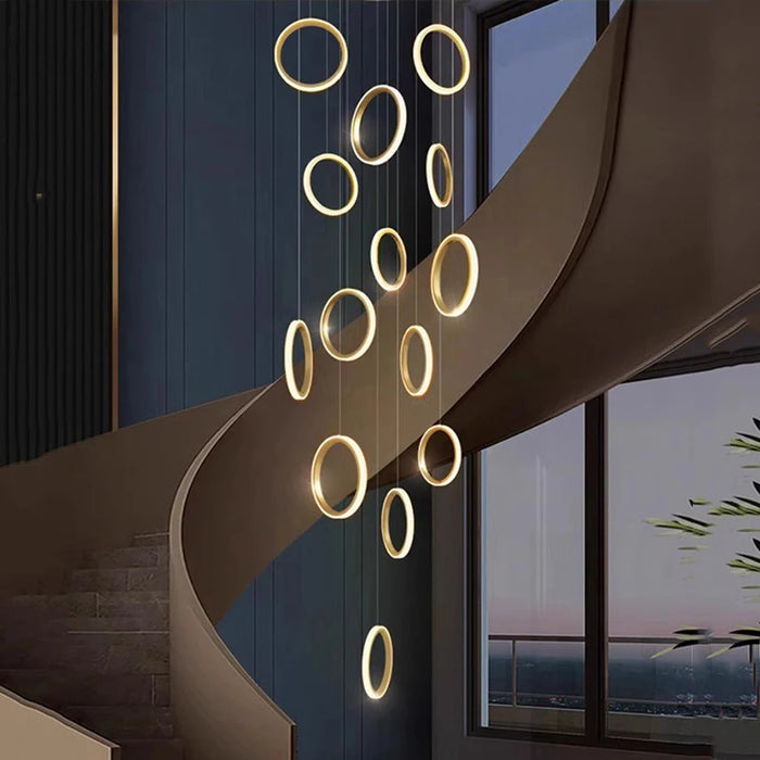 Elegant Nordic rings pendant chandelier illuminating a modern staircase with Scandinavian style.