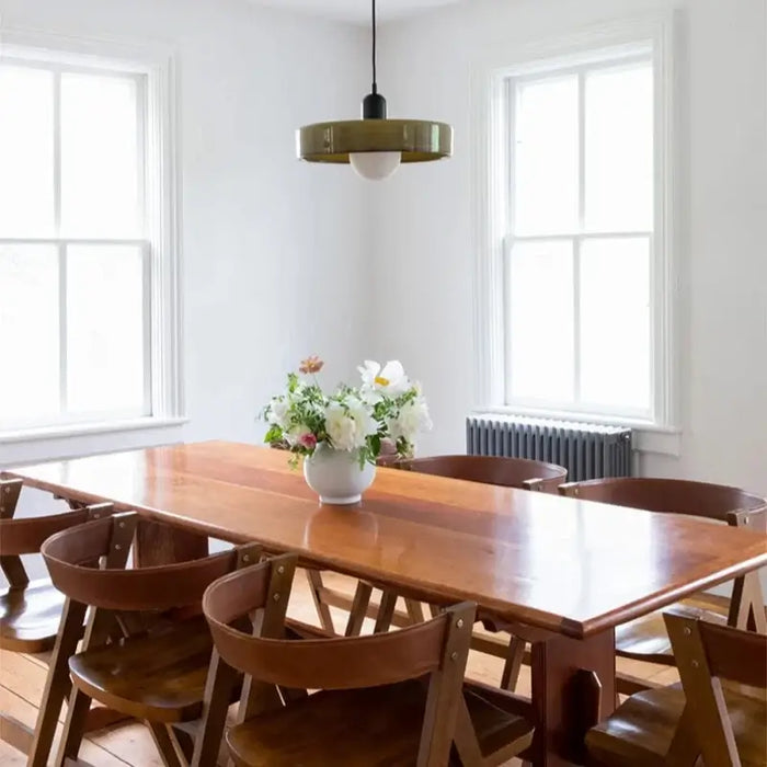 Retro glass pendant light in dining room with wooden table and chairs, vintage interior style.