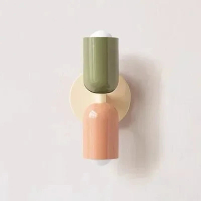 Modern colorful bedside wall lamp in green and peach, featuring a metal design, perfect for adding style and function to any room.