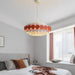 Vibrant Retro Circular Chandelier with colorful disks hanging in a modern bedroom, enhancing the room's playful aesthetic.