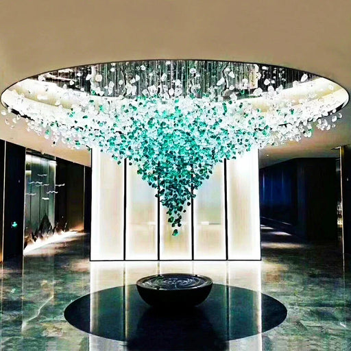 Luxury crystal stone chandelier with LED lighting in modern space, featuring customizable design and polished stainless-steel frame.