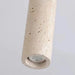 Natural stone cylinder ceiling light with minimalist design for elegant interior illumination.