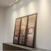 Copper adjustable LED ceiling lights illuminating framed art in a modern interior setting.