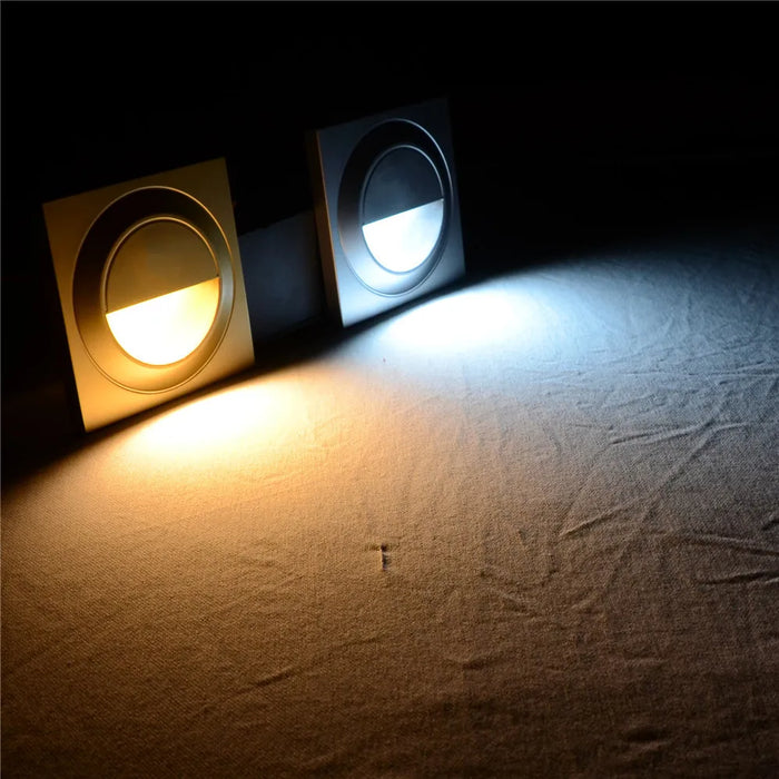 Recessed LED Stai Walkway Light displaying dual color options, warm white and white, on a textured surface.