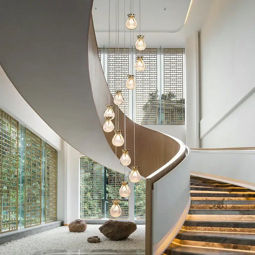 Modern staircase with Nordic Luxury Lucky Bag Chandelier featuring elegant, hanging LED bulbs for high ceilings.